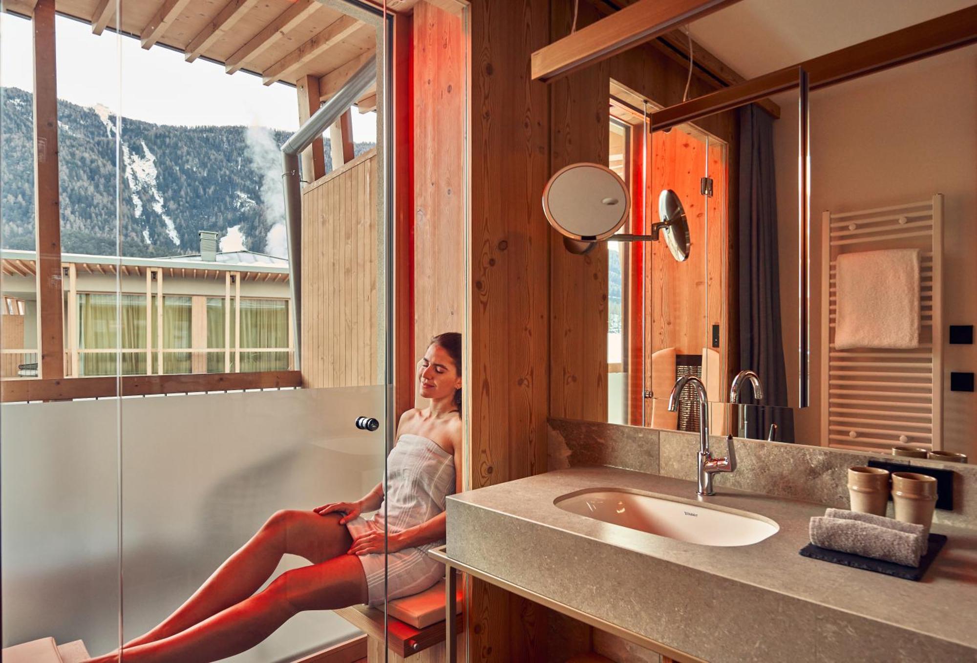 ריסקונה Falkensteiner Hotel Kronplatz - The Leading Hotels Of The World (Adults Only) חדר תמונה A woman in a shower